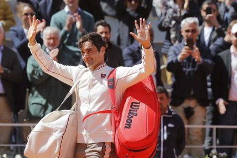 Switzerland's Roger Federer waves goodbye after losing his semifinal match of the French Open tennis tournament against Spain's Rafael Nadal in three sets 3-6, 4-6, 2-6, at the Roland Garros stadium in Paris, Friday, June 7, 2019. (AP Photo/Michel Euler)