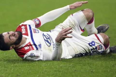 Lyon's Nabil Fekir lies on the pitch during the French League One soccer match between Lyon and Guingamp at the Stade de Lyon near Lyon, France, Friday, Feb. 15, 2019. (AP Photo/Laurent Cipriani)