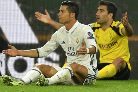 Real Madrid's Cristiano Ronaldo, left, and Dortmund's Sokratis Papastathopoulos raise their hands after making contact during the Champions League group F soccer match between Borussia Dortmund and Real Madrid in Dortmund, Germany, Tuesday, Sept. 27, 2016. (AP Photo/Martin Meissner)