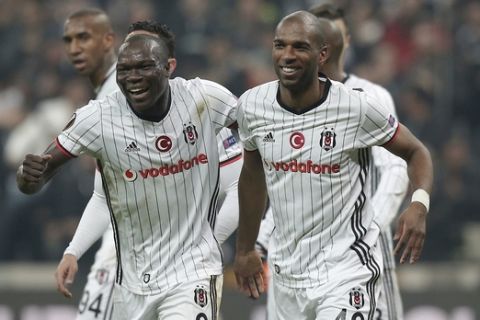 Besiktas' Vincent Aboubakar, left, and Ryan Babel, celebrate their team's goal against Olympiakos during a Europa League round of 16 second leg soccer match between Besiktas and Olympiakos, in Istanbul, Thursday, March 16, 2017. Besiktas won the match 4-1 and was qualified. (AP Photo/Emrah Gurel)