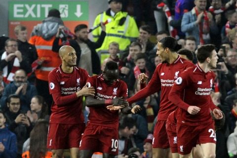 Liverpool's Sadio Mane, second left, celebrates with teammates after scoring his side's opening goal during the English Premier League soccer match between Liverpool and Watford at Anfield stadium in Liverpool, England, Wednesday, Feb. 27, 2019. (AP Photo/Rui Vieira)