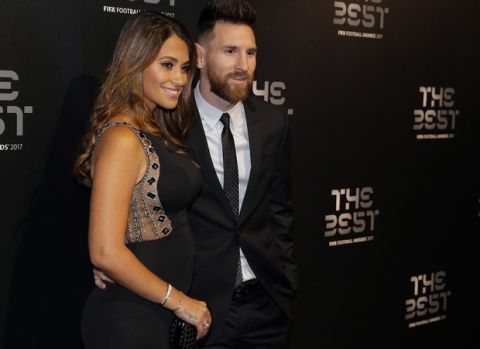 Soccer player Lionel Messi and wife Antonella arrive to attend The Best FIFA 2017 Awards at the Palladium Theatre in London, Monday, Oct. 23, 2017. (AP Photo/Alastair Grant)