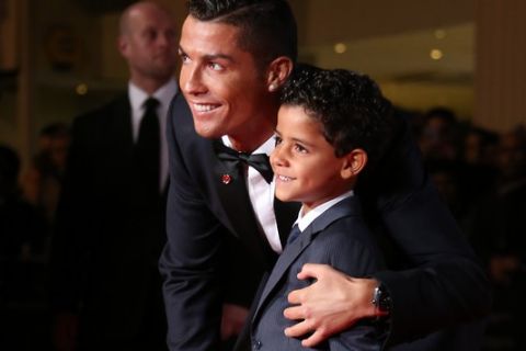 Cristiano Ronaldo, left, and his son Cristiano Ronaldo Junior  pose for photographers upon arrival at the world premiere of the film 'Ronaldo, in London, Monday, Nov. 9, 2015. (Photo by Joel Ryan/Invision/AP)