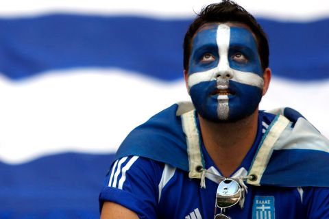 A Greek fan sits in the stands prior to the Euro 2012 soccer championship Group A  match between Greece and Russia in Warsaw, Poland, Saturday, June 16, 2012. (AP Photo/Thanassis Stavrakis)