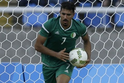 Algeria's Baghdad Bounedjah picks up the ball after scoring against Honduras as Honduras goalkeeper Luis Lopez lies on the grounds and Marcelo Pereira walks away, during a group D match of the men's Olympic football tournament at the Rio Olympic Stadium in Rio De Janeiro, Brazil, Thursday, Aug. 4, 2016. (AP Photo/Leo Correa)