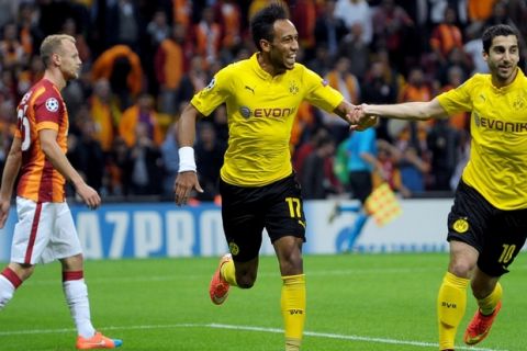 Dortmund's Gabonese forward Pierre-Emerick Aubameyang celebrates (C) with Dortmund's Armenian forward Henrikh Mkhitaryan (R) after scoring a goal the UEFA Champions League Group D football match between Galatasaray and Borrusia Dortmund on October 22, 2014 at the Turk Telecom Arena in Istanbul. AFP PHOTO /OZAN KOSE        (Photo credit should read OZAN KOSE/AFP/Getty Images)