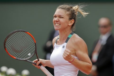 Romania's Simona Halep celebrates winning her fourth round match against Spain's Carla Suarez Navarro in two sets, 6-1, 6-1, at the French Open tennis tournament at the Roland Garros stadium, in Paris, France. Monday, June 5, 2017. (AP Photo/Michel Euler)