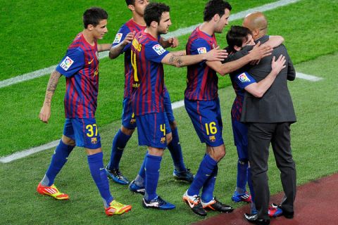 Barcelona's players celebrates with Barcelona's coach Josep Guardiola after scoring a goal during the Spanish league football match FC Barcelona vs RCD Espanyol on May 5, 2012 at the Camp Nou stadium in Barcelona. AFP PHOTO/ JOSEP LAGOJOSEP LAGO/AFP/GettyImages