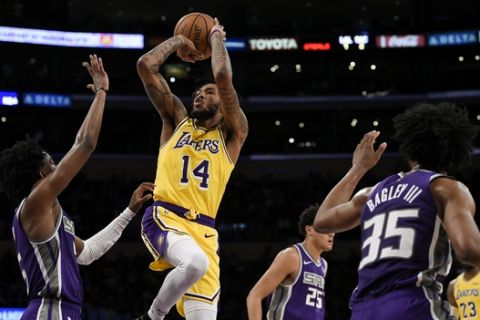 Los Angeles Lakers forward Brandon Ingram attempts a shot while defended by Sacramento Kings guard De'Aaron Fox, left, as Kings forward Marvin Bagley III watches during the first half of an NBA preseason basketball game in Los Angeles, Thursday, Oct. 4, 2018. (AP Photo/Kelvin Kuo)