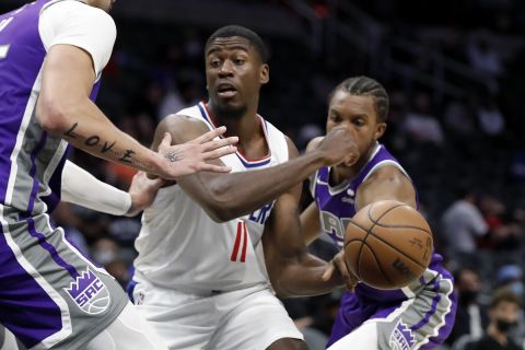 Sacramento Kings forward Louis King, right, knocks the ball out of the hands of Los Angeles Clippers forward Moses Wright (11), with center Alex Len (25) defending during the second half of a preseason NBA basketball game Wednesday, Oct. 6, 2021, in Los Angeles. (AP Photo/Alex Gallardo)