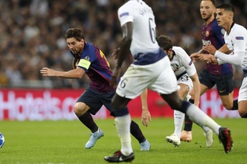 Barcelona forward Lionel Messi, left, runs for a ball during the Champions League Group B soccer match between Tottenham Hotspur and Barcelona at Wembley Stadium in London, Wednesday, Oct. 3, 2018. (AP Photo/Frank Augstein)