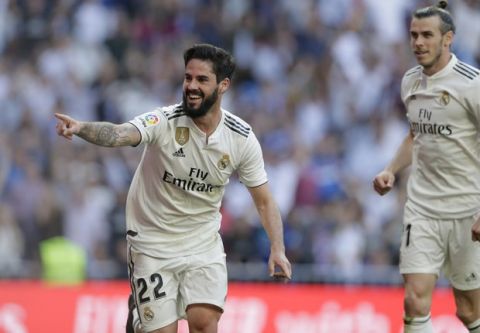 Real Madrid's Isco celebrates after scoring during a Spanish La Liga soccer match between Real Madrid and Celta at the Santiago Bernabeu stadium in Madrid, Spain, Saturday, March 16, 2019. At right his Real Madrid's Gareth Bale. (AP Photo/Paul White)