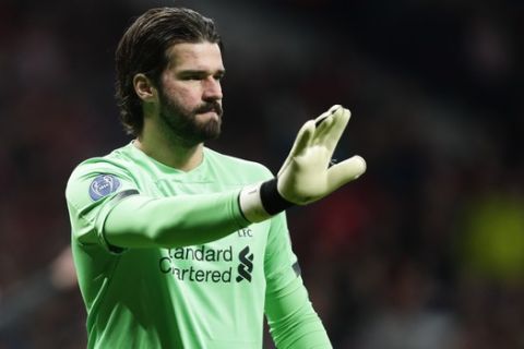 Liverpool's goalkeeper Alisson instructs his teammates during a 1st leg, round of 16, of the Champions League soccer match between Atletico Madrid and Liverpool at the Wanda Metropolitano stadium in Madrid, Tuesday, Feb. 18, 2020. (AP Photo/Manu Fernandez)