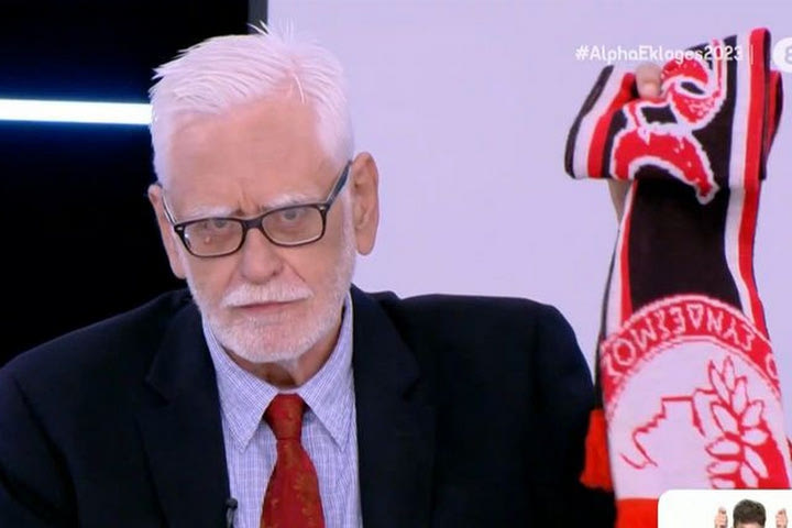 Ο πολιτικός αναλυτής Γιώργος Προκοπάκης με κασκόλ του Ολυμπιακού